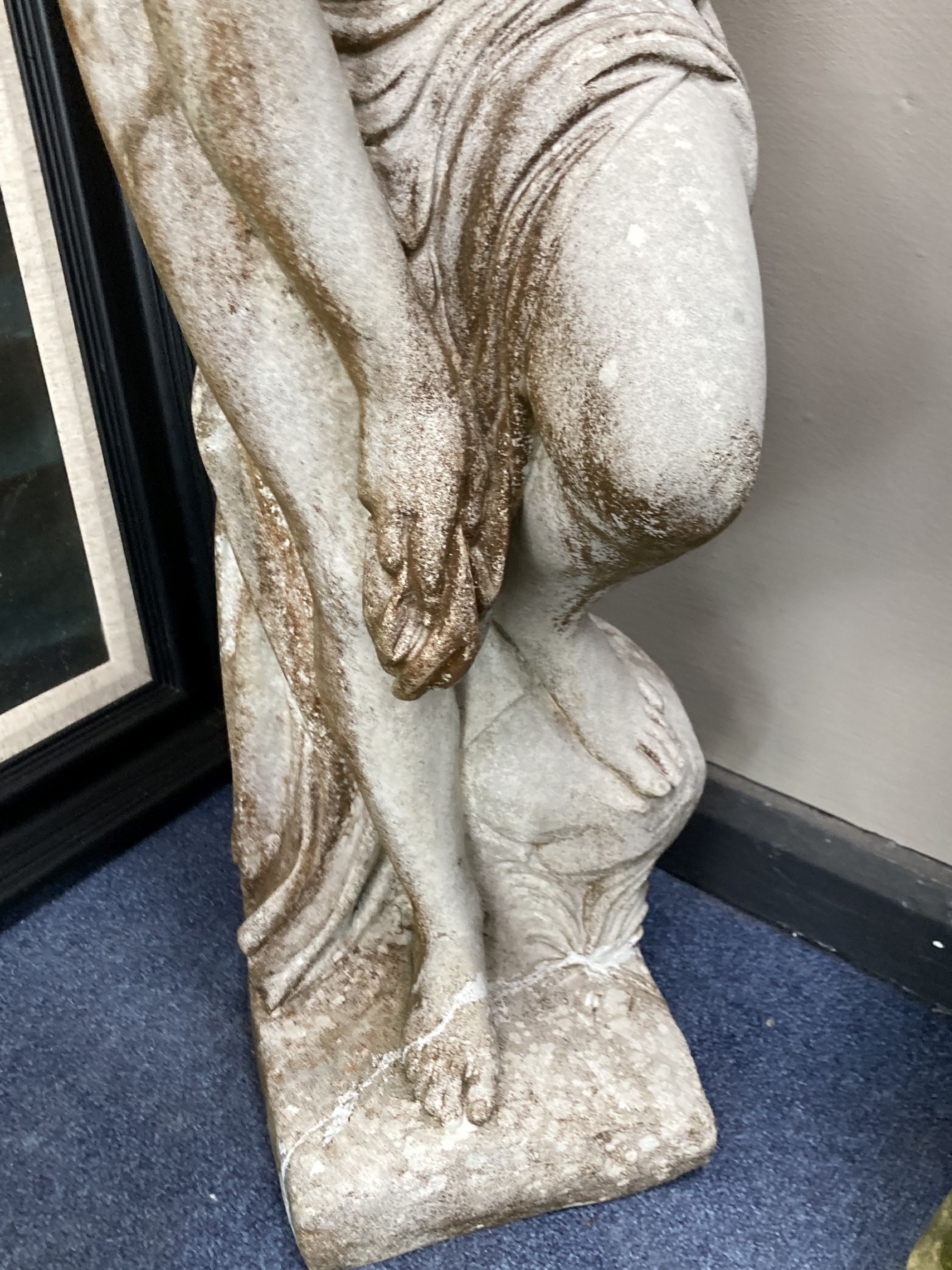 A reconstituted stone garden ornament of a female bather, 86cm high